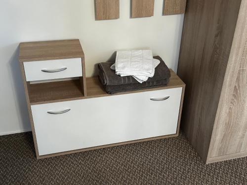 a white cabinet with two drawers at Taverna Unik in Saaldorf