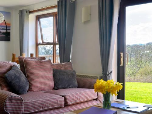 a living room with a couch and a table at Keel Cottage in Whitby