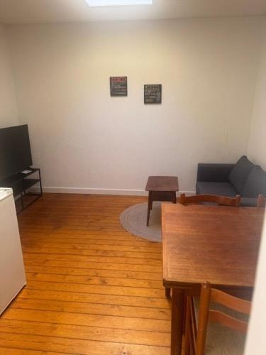 a living room with a couch and a table at Havfruens Lejlighed in Rødby