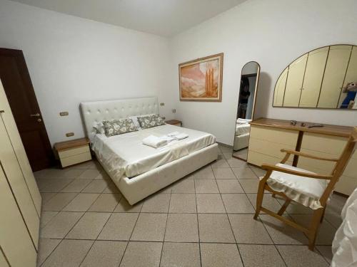 a bedroom with a bed and a desk and a chair at Casa vacanze Castellara in Bevagna