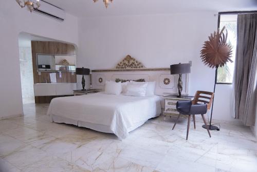 a bedroom with a bed and a desk and a chair at Villa Maraf - Adults Only Boutique Hotel in Cancún