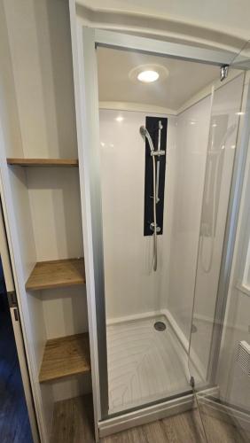 a walk in shower with a glass door at Eden 1708 in Canet-en-Roussillon