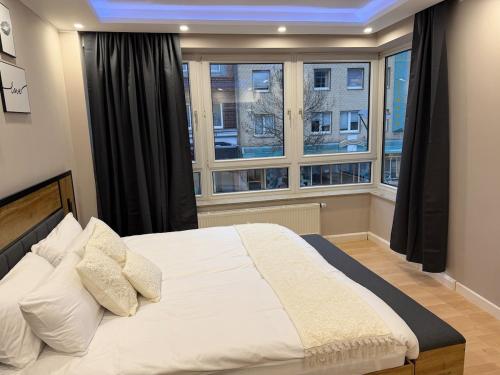 a bedroom with a large bed in front of a window at Rheinperle Wesel in Wesel