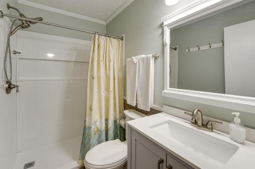 a bathroom with a sink and a toilet and a mirror at Ocean-View Balcony! Myrtle Beach 3rd-Floor Retreat in Myrtle Beach