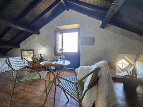 a room with a table and chairs and a window at Ocean View - Nordeste in Feteira Grande