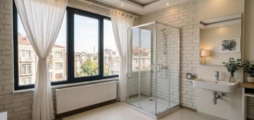 a bathroom with a shower and a sink and a window at pınar apart hotel in Kapuluören