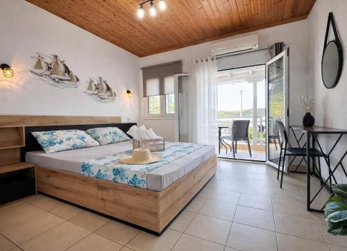a bedroom with a bed and a table and chairs at Puerto Porto Koufo in Porto Koufo