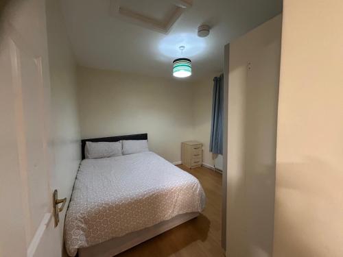 a small bedroom with a bed and a light at Lime House in Hayes