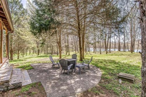 a patio with a table and chairs in a park at Luxury Lakefront Cabin in Castalian Springs