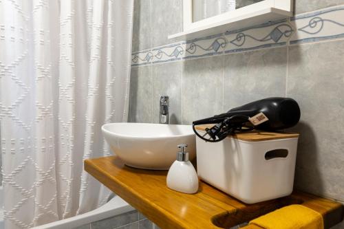 a bathroom with a sink and a mixer on a counter at Apartamentos do Triângulo in Velas
