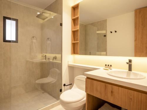 a bathroom with a toilet and a sink and a shower at Bomma House - Parque 93 in Bogotá