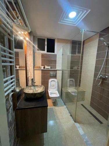 a bathroom with a sink and a toilet and a shower at Hsan Bouslimi in Ez Zahra