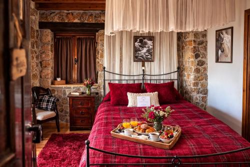 a bed with a tray of food on it at Petrino Lodge Stone Mountain Retreat in Kato Trikala Korinthias