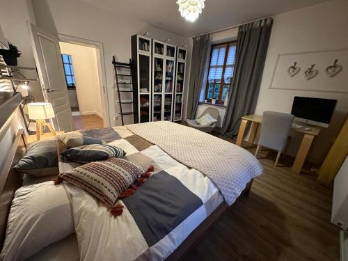 a bedroom with a large bed and a desk with a computer at Dako Apartment, Luxurious, Cosy, Spacious in Rzeszów