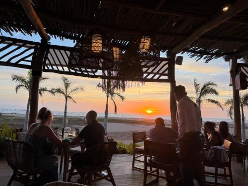 a group of people sitting at a table on the beach at 2bd apartment in Nuevo Vallarta