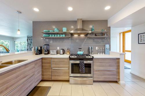 a kitchen with a stove and a sink at Desert Retreat in Indian Wells