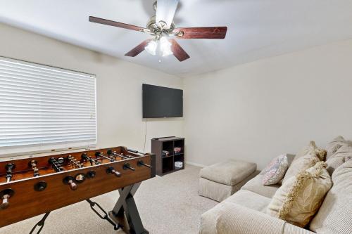 a living room with a couch and a ceiling fan at Evening Star in Indian Wells