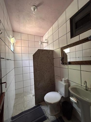 a bathroom with a toilet and a sink at Pousada Beira Rio Cipó in Serra do Cipo