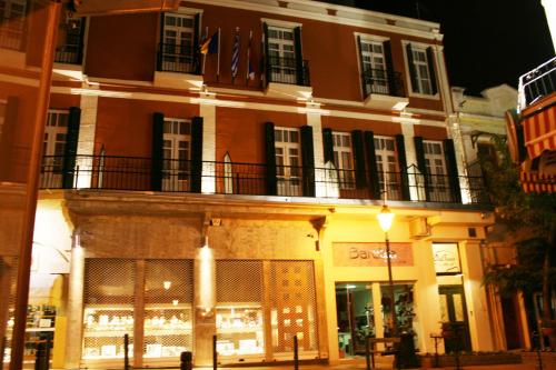a building with a balcony on the side of a street at Old Town Inn in Kavala