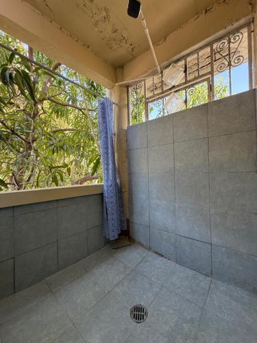 an empty room with a window and a grate at TerraZica hostal in Brisas de Zicatela