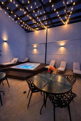 a room with a swimming pool with a table and chairs at Suite privada en hotel Boutique in Bogotá