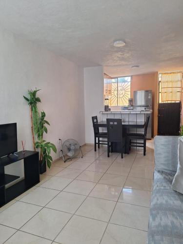 a living room with a couch and a table at Departamento cerca de la playa in Puerto Vallarta