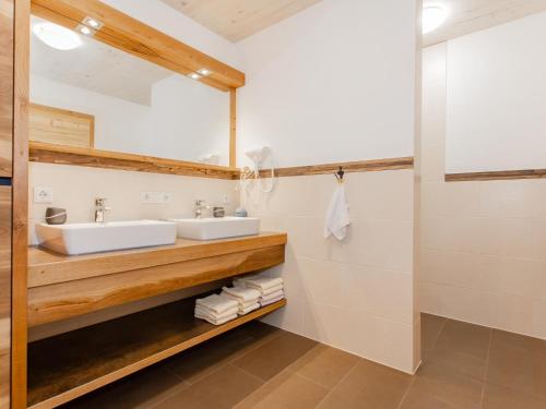 a bathroom with a sink and a mirror at Das Rendlgut Top 4 in Lofer