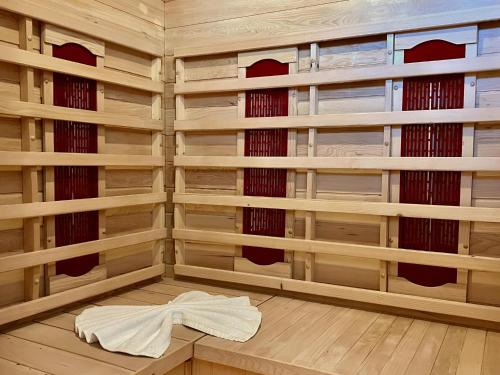 a sauna with wooden shelves and a towel on the floor at Gipfelglück in Sankt Lambrecht
