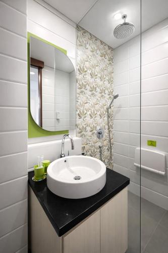 a bathroom with a sink and a mirror at DK Belstar Hotel Belitung in Tanjungpandan