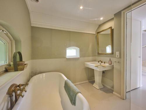 a bathroom with a tub and a sink at Design Lodge Twente in Haaksbergen