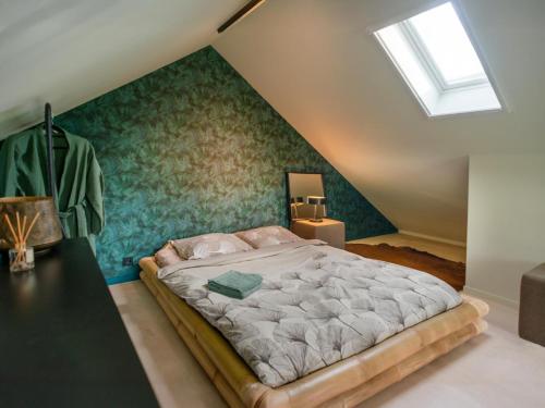 a bedroom with a large bed in a attic at The Green Wellness Cabin in Haaksbergen