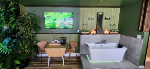 a bathroom with a tub and a table and chairs at Zen Retreat-Jacuzzi, kitchenette, Walk to fun in Reno