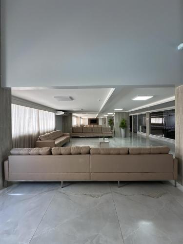 a large living room with a large couch in the middle at Spazzio diRoma com acesso ao Acqua Park in Caldas Novas