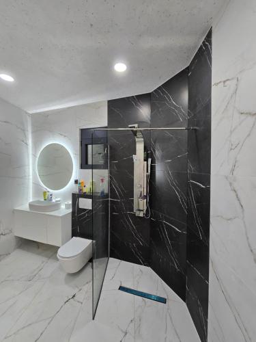 a bathroom with a toilet and a sink and a mirror at Vila SOL DEL MAR in Utjeha