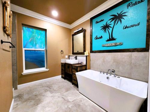 a bathroom with a large tub and a sink at Tropical Spa Studio, Jacuzzi, Kitchen, Sparks in Sparks