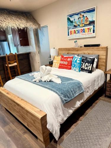 a bedroom with a large bed with pillows at Tropical Spa Studio, Jacuzzi, Kitchen, Sparks in Sparks