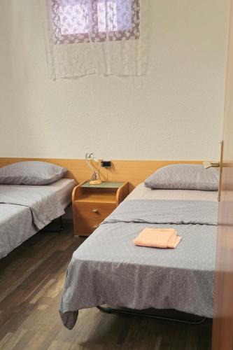 a room with two beds and a window at Seaside holiday house Drasnice, Makarska - 10359 in Drasnice