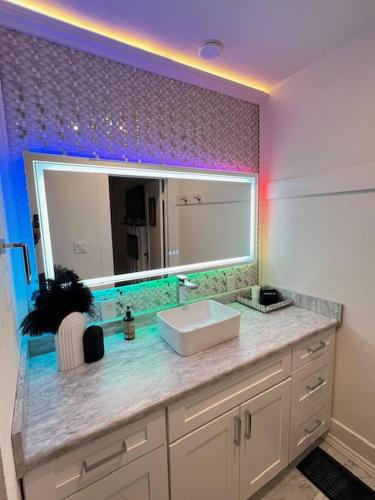 a bathroom with a sink and a large mirror at Deco Studio Retreat with Fireplace, WiFi, Queen Bed in Reno