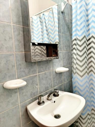 a bathroom with a sink and a mirror at Casa Luis del carmen in Fiambalá