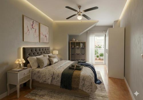 a bedroom with a bed and a ceiling fan at Piso Luna in Mojácar