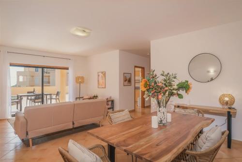 a living room with a table and a couch at Terrace View - Estrela Apartment in Luz