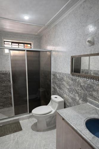 a bathroom with a toilet and a shower and a sink at Hotel ladymar cartagena in Cartagena de Indias