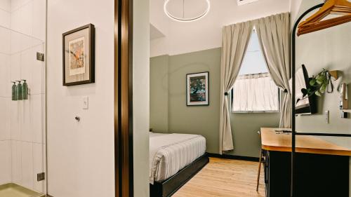 a bedroom with a bed and a sink and a window at Violet Inn, Lounge & Spa in Two Rivers