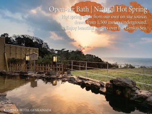 an open air bath natural hot spring with the ocean in the background at KAMENOI HOTEL Genkainada in Kitakyushu