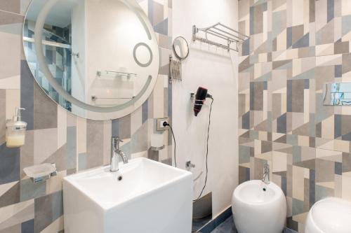 a bathroom with a sink and a mirror at Federico 70 Zaffiro Luxury in Palermo