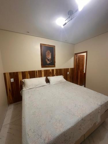 a bedroom with a large bed in a room at Pousada Safari do Jaguar in Poconé