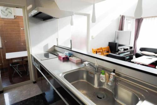 a kitchen with a sink and a counter at STAY IN TOYOOKA in Asahikawa