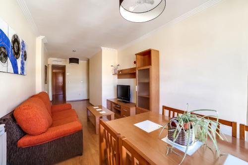 a living room with a couch and a table at Apartamentos Legazpi in Albacete