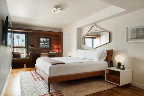 a bedroom with a bed and a desk in it at SIXTY Beverly Hills in Los Angeles