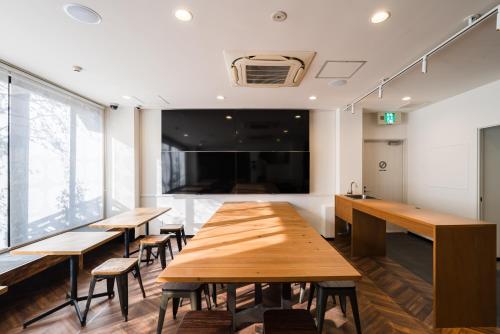 a conference room with wooden tables and chairs at OKINI - Doyanen Hotels in Osaka